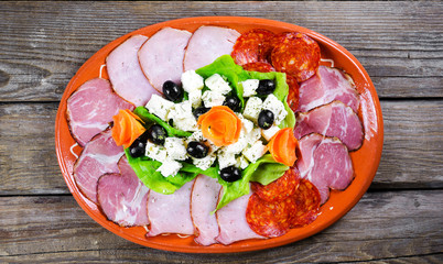 Appetizer on the plate and the old wooden table
