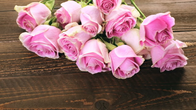Pink roses on rustic wood table