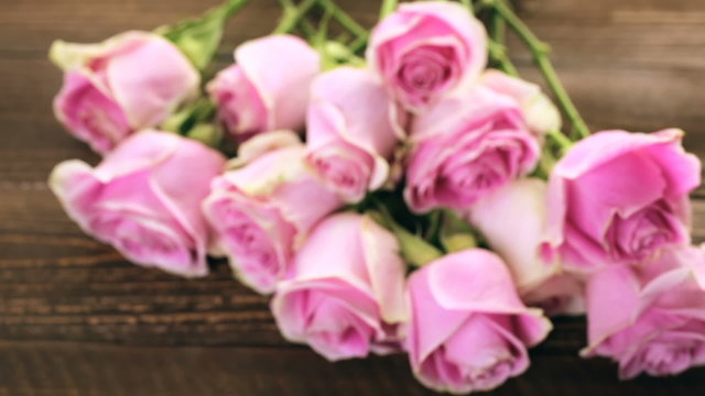 Pink roses on rustic wood table