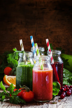 Mix of healthy fruit and vegetable juices in small bottles with