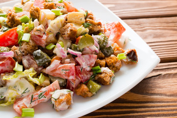 vegetable salad with mayonnaise in white plate closeup