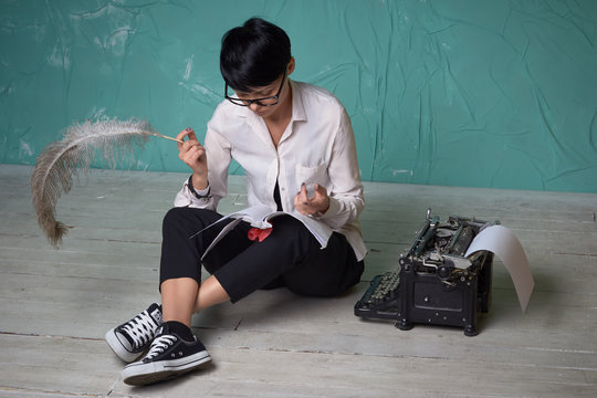 Young  business woman working with documents on floor, retro typewriter
