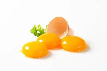 Tuinposter Raw egg yolks © Viktor