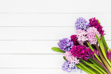Bouquet of pink hyacinth flowers on white wooden background. Top view, copy space 