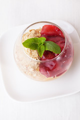 strawberry nut dessert in a glass with mint, crushed peanuts, walnuts