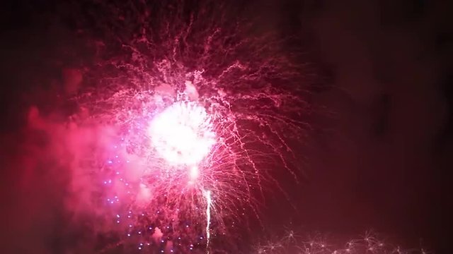 Big pink and violet midnight fireworks in Sydney sky to celebrate the new year 2015, video  from a boat in the Harbour