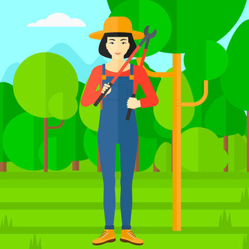 Farmer with pruner in garden.