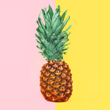 Pineapple fruit on colorful yellow pink background, ananas photo