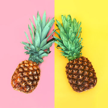Two pineapple lying on colorful background, ananas concept