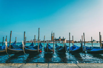 Retro filtered image of gondolas near Saint Mark square with San Giorgio di Maggiore church in the background - Venice, Venezia, Italy, Europe