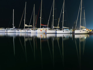 Marina with docked yachts at night in Hurghada, Egypt