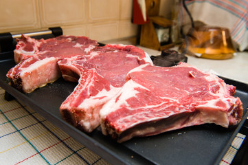 Three beef steaks on the grill