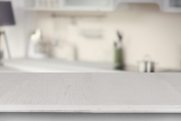 Empty wooden table and blurred kitchen background