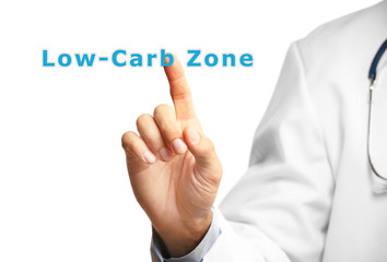 Doctor pointing on Low-Carb Zone text isolated on white