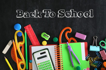 Colourful stationery on blackboard background