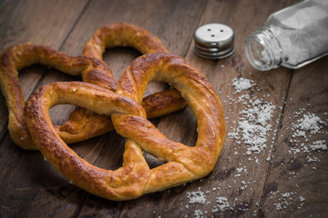 Pretzels with salt on wooden table