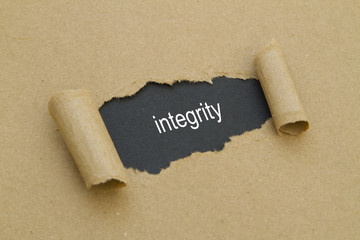 integrity word written under torn paper.