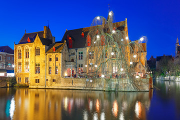 Fototapeta na wymiar Scenic panorama with medieval fairytale town and tower Belfort from the quay Rosary, Rozenhoedkaai, in the evening, Bruges, Belgium