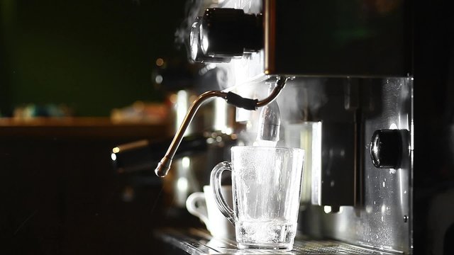 Color footage of a barista pouring hot water in a glass.