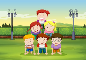 Kids doing human pyramid in the park