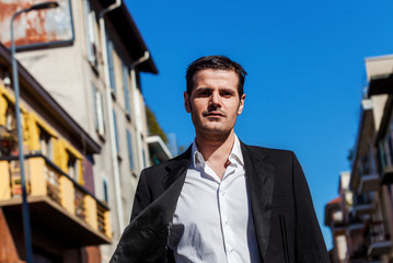 Handsome and relaxed man portrait walking in the city