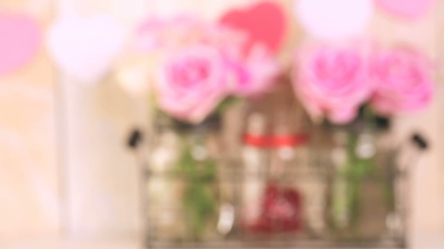 Pink roses in jars and gifts on rustic wood shelf for Valentines DAy