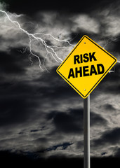 Risk Ahead Warning Sign Against Stormy Sky