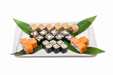 Sushi set: a plate of rolls and maki isolated on white background © mafffi