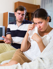 Upset spouses after domestic quarrel.