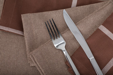 Top view of the beautiful decorated table with linen napkins and cutlery on luxurious tablecloth