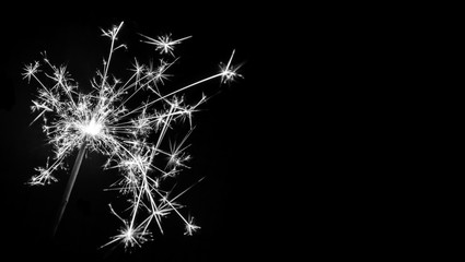 Fototapeta premium Christmas sparkler on black background. Bengal fire