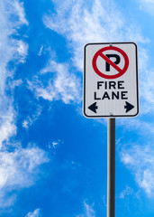 Fire Lane No Parking Sign Against Blue Sky