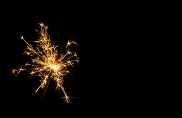 Christmas sparkler on black background. Bengal fire