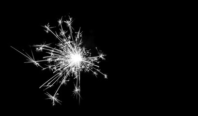 Fototapeta premium Christmas sparkler on black background. Bengal fire