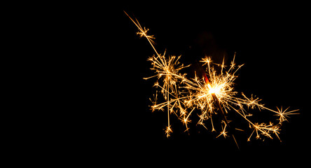 Fototapeta premium Christmas sparkler on black background. Bengal fire