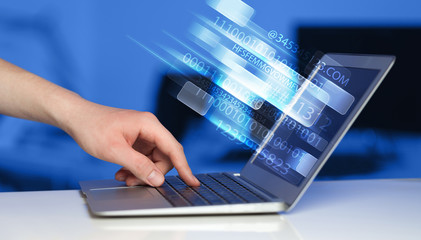 Fototapeta na wymiar Close up of man typing on laptop computer