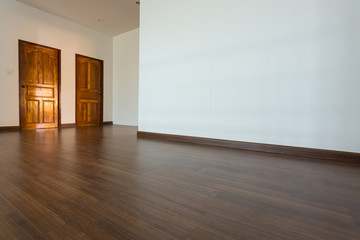 Fototapeta na wymiar empty room, white mortar wall background and wood laminate floor