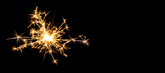 Christmas sparkler on black background. Bengal fire - Powered by Adobe