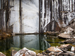 Pool in abandoned old marble quarry. Still waters.