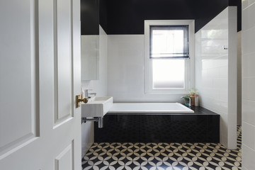 Designer bathroom renovation black and white floor tiles horizon
