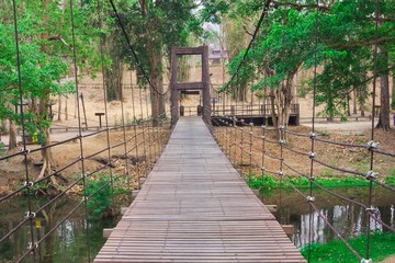 Fototapeta premium suspension bridge of iron chain and woods in the forest