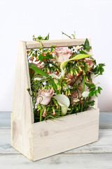 Wooden box with roses and zantedeschia flowers