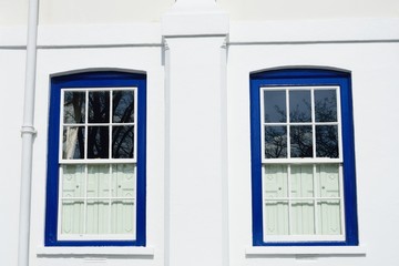Traditional Blue windows on white walls