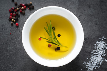 Black food background with olive oil and spices