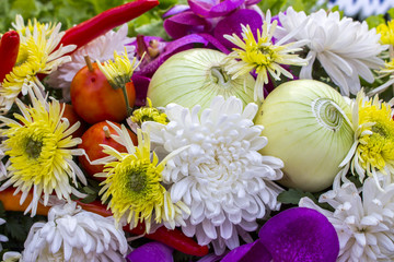 Vegetables and flowers composition: onion, red pepper, tomatoes,chrysanthemums