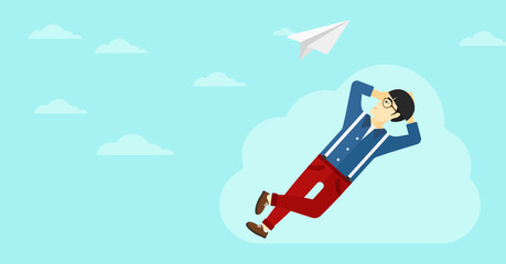 Businessman relaxing on cloud.