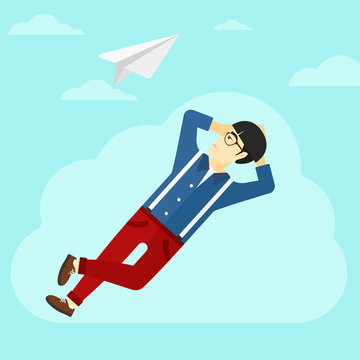 Businessman relaxing on cloud