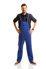 Young repairman posing on white background