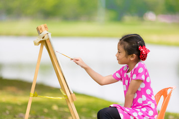 Little asian girl painitng