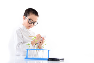 Young Asian boy check plant seedling in laboratory